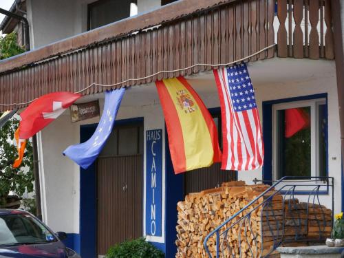 a group of flags hanging outside of a building at Haus Camino in Löffingen