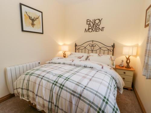 a bedroom with a bed and a sign on the wall at Wagtail Nest in Scarborough