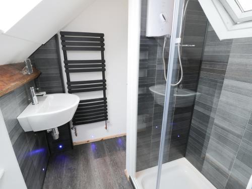 a bathroom with a sink and a shower at 53 Burniston Road in Scarborough