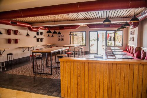 a restaurant with a bar with tables and chairs at Marrakech Ryads Parc All inclusive in Marrakech