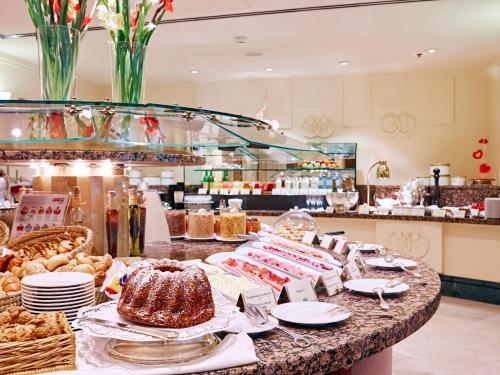 a buffet of food on a table in a kitchen at Grand Hotel Wien in Vienna
