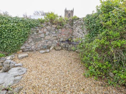 a stone wall with a bench in front of it at Bryn Haf, New Street in Beaumaris