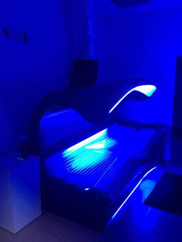 a dark room with a bed with a blue light at OC Panorama in Velké Meziříčí