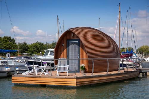 a small wooden boat sitting in the water at Samphire Ark 900 in Emsworth