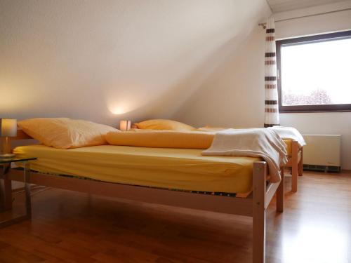 two twin beds in a room with a window at Haus Philipp in Bad Urach