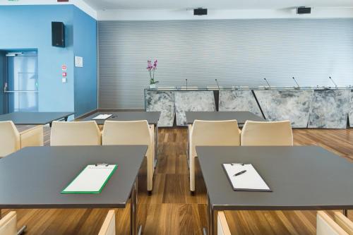 a dining room with tables and chairs in a room at Camplus Bononia Casa per Ferie in Bologna