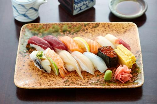 a plate of food with sushi on a table at Grand Hotel Wien in Vienna
