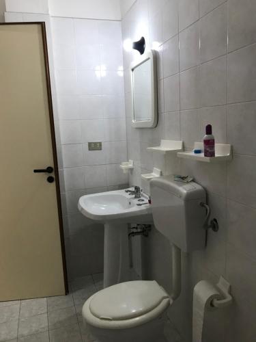 a bathroom with a sink and a toilet and a mirror at Villa Raffa Salento in Maruggio