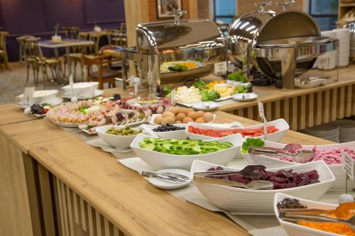 a buffet line with different types of food on it at Iveria Inn Hotel in Tbilisi City