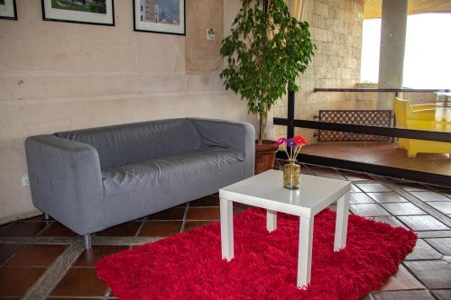 a living room with a couch and a table at HI Almada - Pousada de Juventude in Almada