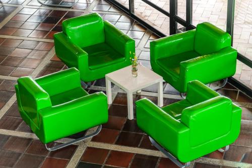 a group of green chairs and a table at HI Almada - Pousada de Juventude in Almada