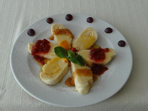 a white plate of food with bananas and raisins at Rooms Hochkraut in Celje