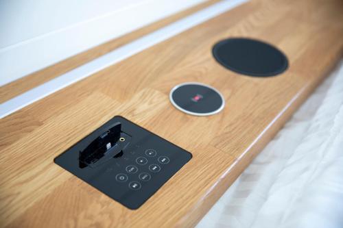 a remote control sitting on top of a wooden table at Samphire Ark 900 in Emsworth