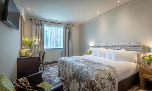 a hotel room with a large bed and a window at Boyne Valley Hotel - Bed & Breakfast Only in Drogheda
