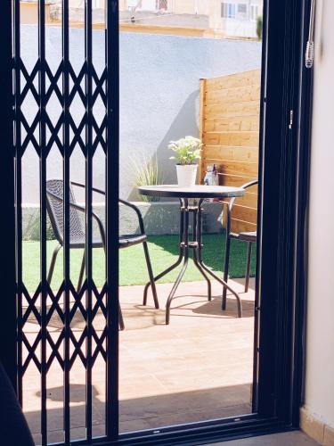 an open door to a patio with a table and chairs at HaBaitBe Matityahu By Domus in Beer Sheva