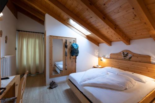 a bedroom with a large bed and a desk at Albergo Aurora in Vignola