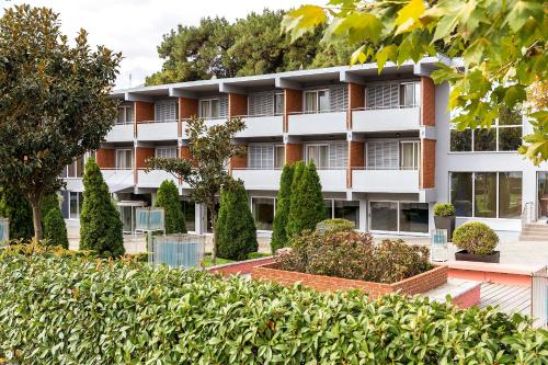 an apartment building with bushes in front of it at Elisso in Xanthi