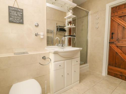 a bathroom with a sink and a shower at The Barn at Orchard Farm in York