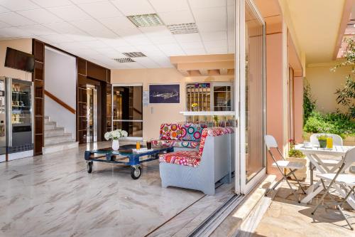 a living room with a couch and a table at Louladakis Apartments in Kolymvari