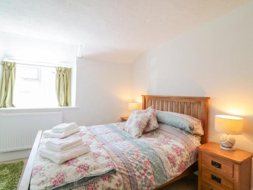 a bedroom with a bed with towels on it at Meadow View Cottage in Exmouth