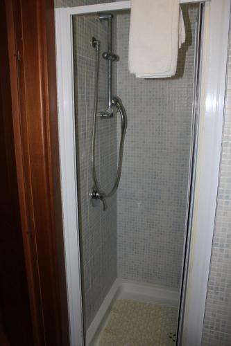a shower in a bathroom with a glass door at B&B Ulivo in Trabia