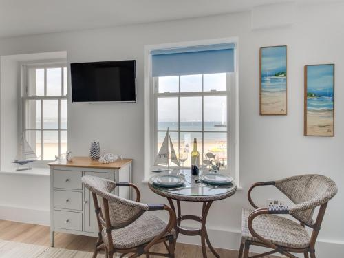a dining room with a table and two chairs at 6 The Beaches in Weymouth