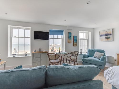 a living room with a couch and chairs and a table at 6 The Beaches in Weymouth
