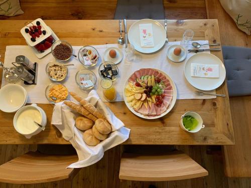 a wooden table with plates of food on it at Schlosstaverne Lunz in Lunz am See