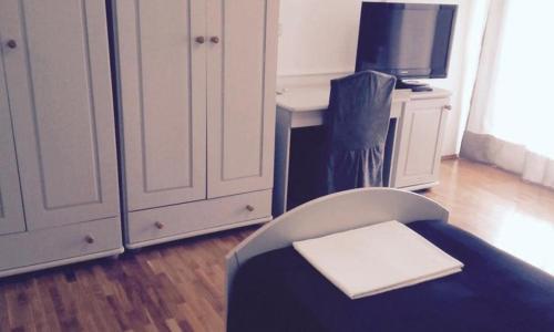 a room with a bed and a desk and a tv at Hotel Vienna in Zagreb
