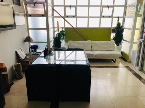 a living room with a couch and a table at Albergue la Estacion Santiago de Compostela in Santiago de Compostela