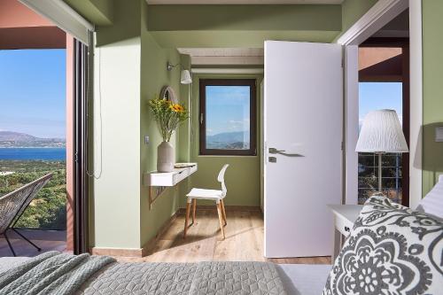 a bedroom with a bed and a desk with a window at Villa Niolos II in Stérnai