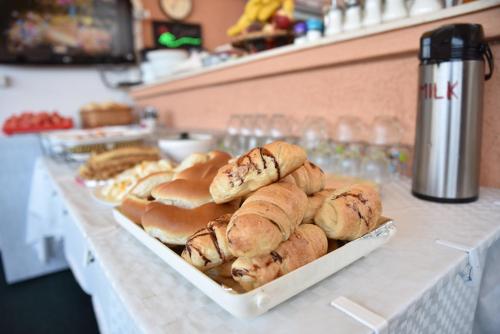 a buffet line with buns and pastries on a counter at Apartments Panorama Alaj in Ulcinj