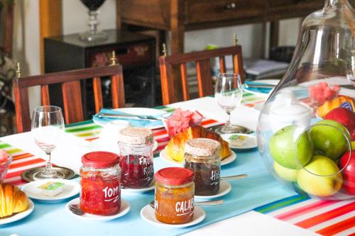 a table with jars of jam and a bowl of fruit at Quinta da Aldeia de Avanca in Avanca