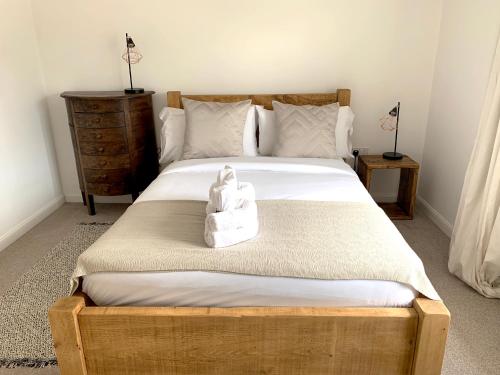 ein Schlafzimmer mit einem Bett mit einer weißen Tasche darauf in der Unterkunft Home Crowd Luxury Apartments- Auckley House in Doncaster