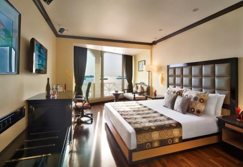 a bedroom with a bed with a view of the ocean at Vivanta Ernakulam, Marine Drive in Cochin