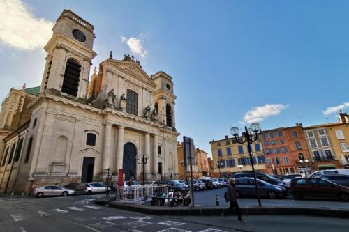 an old church with a clock tower in a city at Le bon'appart - 50m de la cathédrale in Montauban