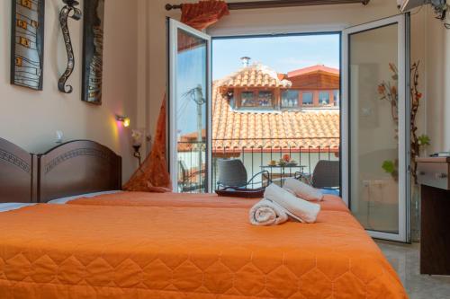 a hotel room with two beds and a large window at Guesthouse Nefeli in Litochoro