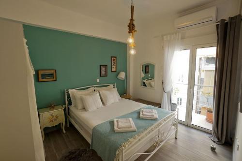 a bedroom with a bed with a green wall at Athens Central Apartment 2 mins to metro in Athens