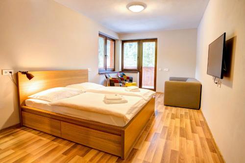 Postel nebo postele na pokoji v ubytování Apartmány Tri Studničky