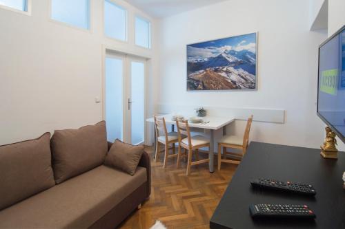 a living room with a couch and a table at Modern Apartment Navrátilova II in Prague