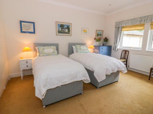 a bedroom with two beds and a window at Sevenacres in Kelso