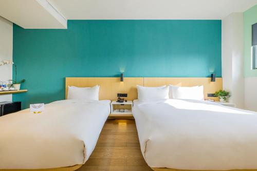 מיטה או מיטות בחדר ב-PACE HOTEL Suzhou Renmin Branch