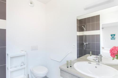 a bathroom with a sink and a toilet at Zenao Appart'hôtels Mulhouse in Mulhouse
