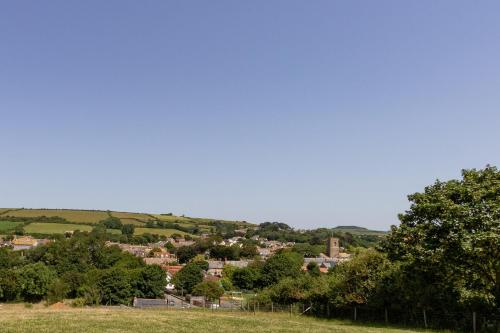 a view of a town from a field with trees at Village View in Bridport