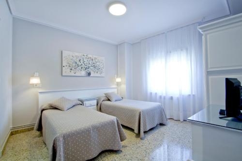 Una cama o camas en una habitación de Hosteria El Capricho