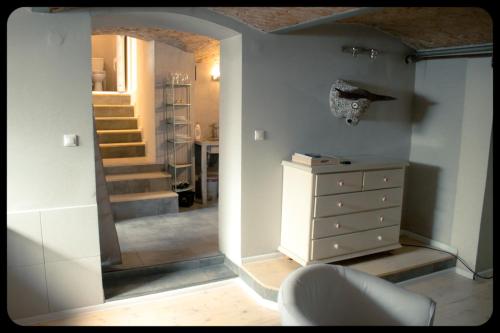a hallway with a dresser and a staircase in a room at Apartamenty 8 in Poznań