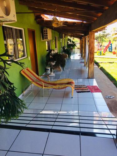 a bench sitting on the floor of a building at Pousada Cantinho de Casa in Nobres