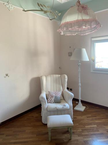 a living room with a chair and a lamp at I Citri in Taranto