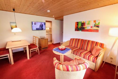 a living room with a couch and a table at Gatterhof in Riezlern