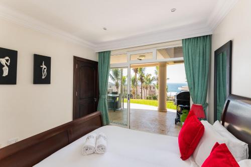 a bedroom with a bed and a view of the ocean at Ballito Manor - Manor View 102 in Ballito